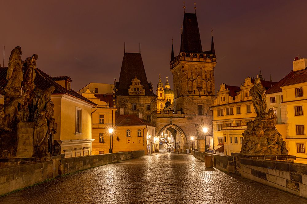 Arch of Lesser Town Bridge Tower on Charles Bridge with St. Nicholas Church in Prague.